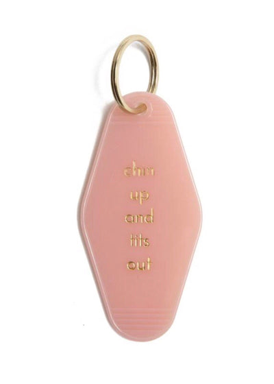 Pink motel style keychain with Chin Up and Tits Out written in white