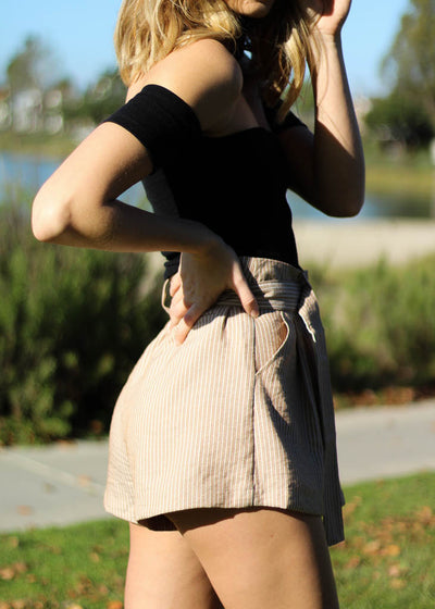 Taupe paperbag shorts with white stripes, pockets and an attached belt