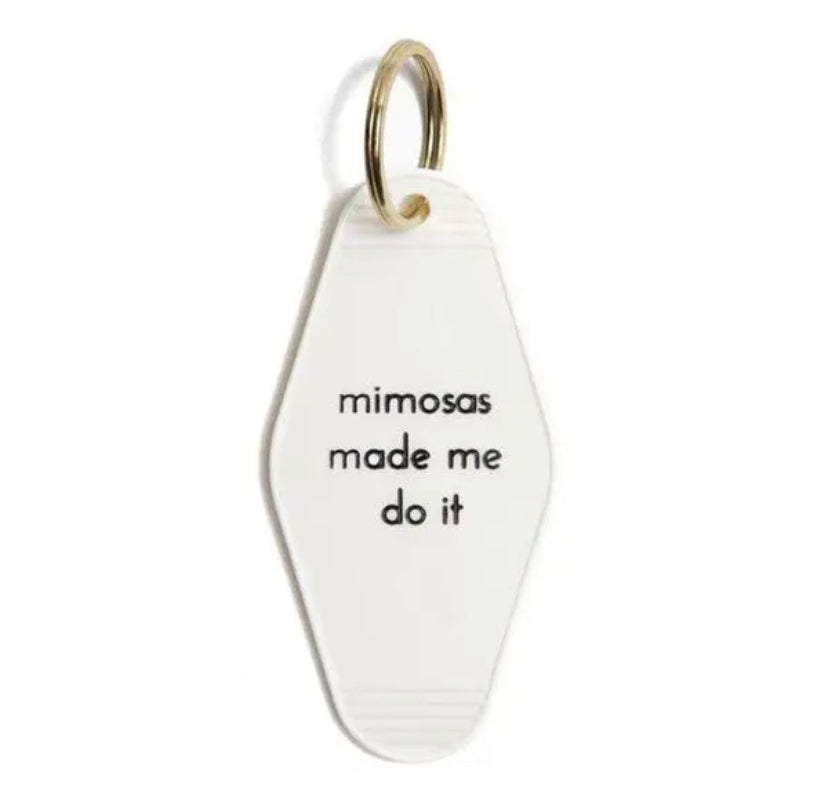 White motel style keychain that says Mimosas Made Me Do It in black