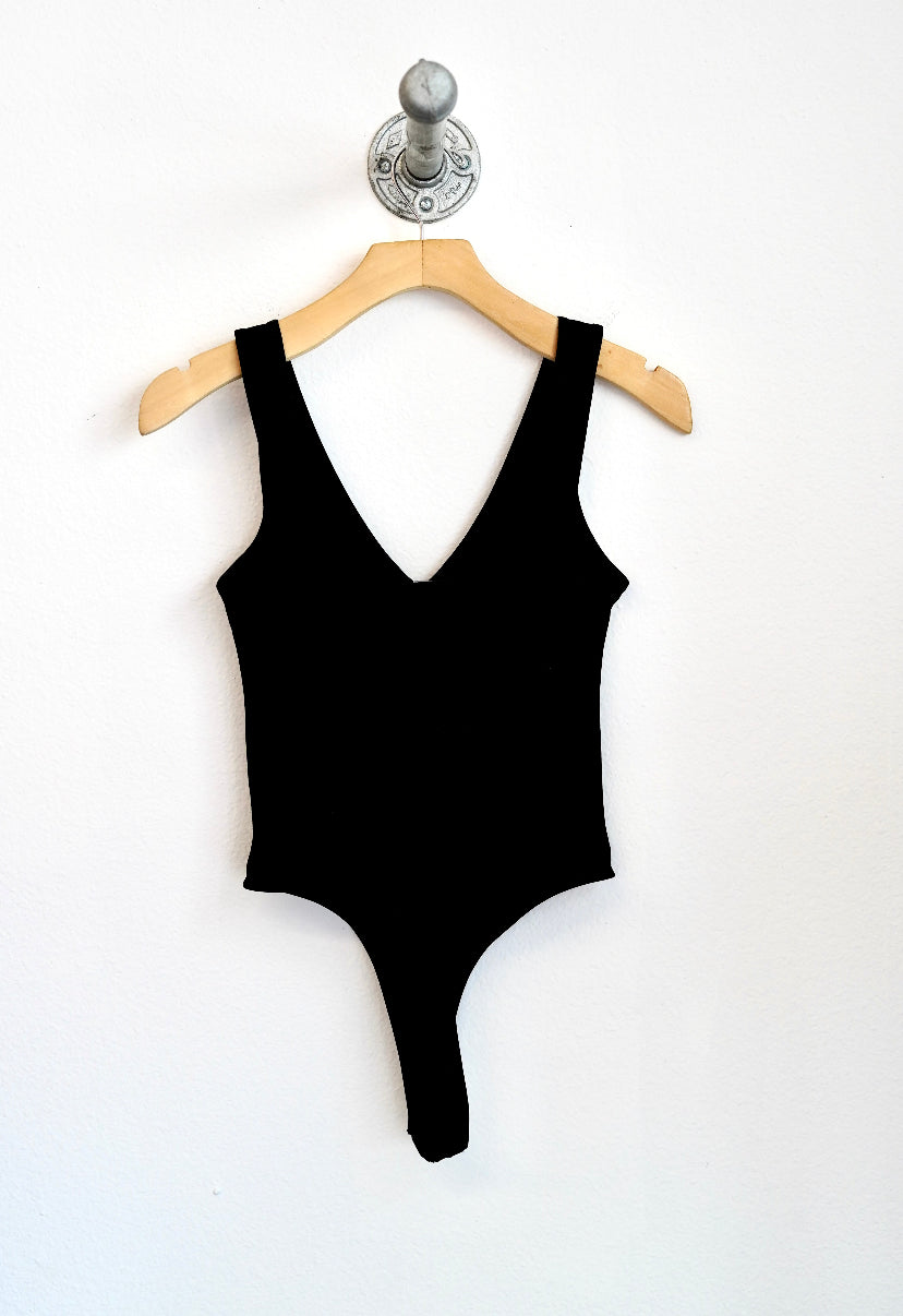 Black bodysuit with a v neckline and thong back with a clasp crotch closure 