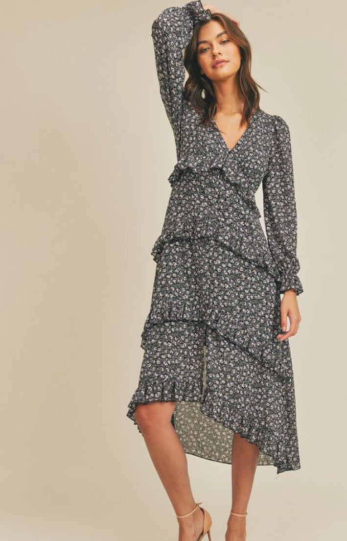 Black midi dress with white floral detail throughout and ruffles with a high/low hemline