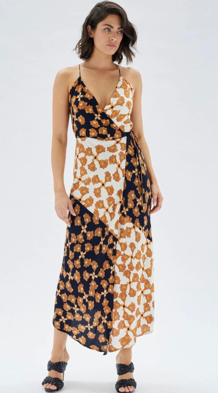 Half white and half black wrap style dress with golden floral detail throughout and front slit with a v neckline