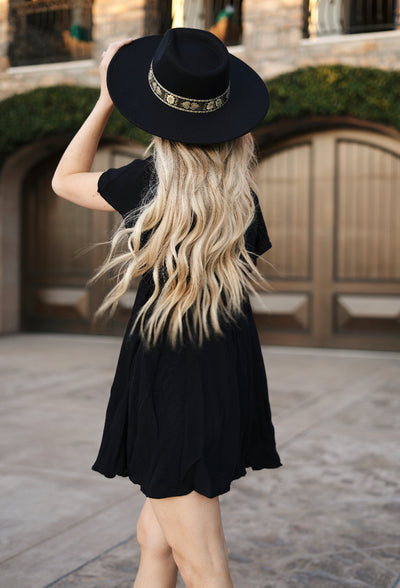 Black mini dress with a button down front and frill sleeves